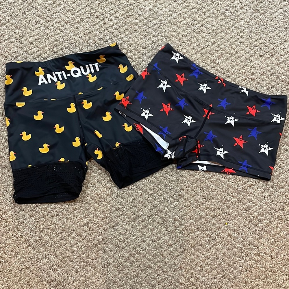 2 pairs of running shorts. Love The Pain and Feed Me Fight Me size L
